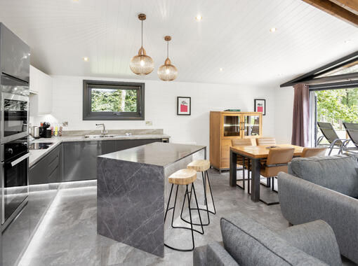 Light and airy modern lounge area with double doors which open out on to verandah