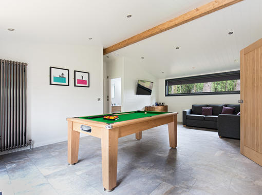 Large games room with pool table and sofa for relaxing