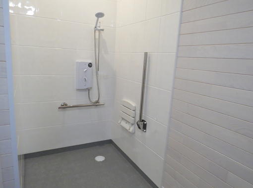 Wet room shower with drop down seat