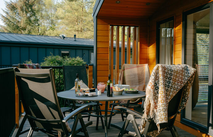 Modern lodge with large decking and hot tub