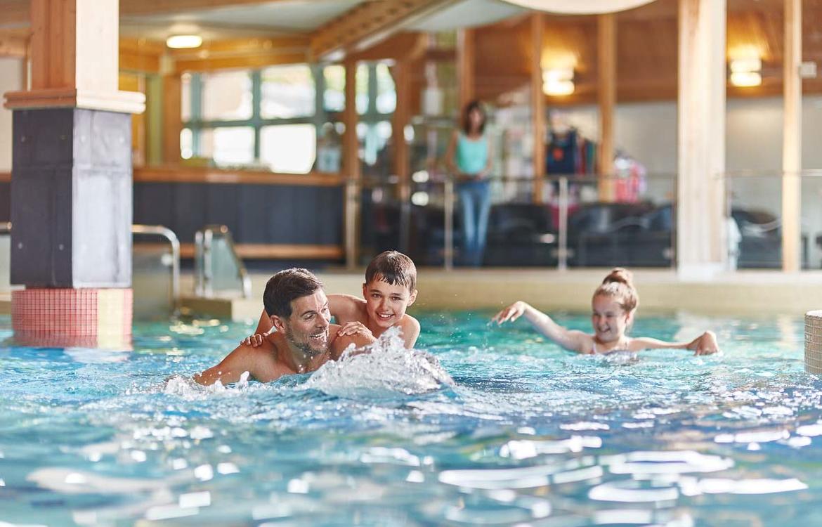 Family playing in the swimming pool