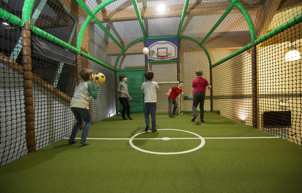 Children playing in the court area with basketball