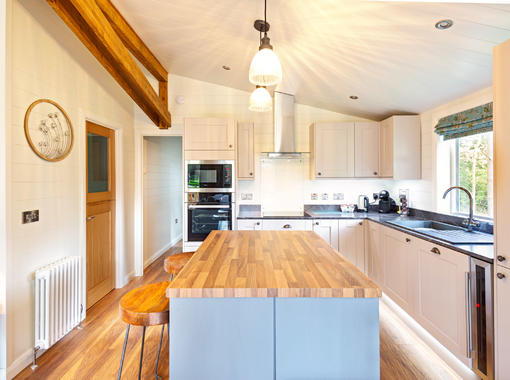 Light and stylish kitchen with central island incorporating breakfast bar