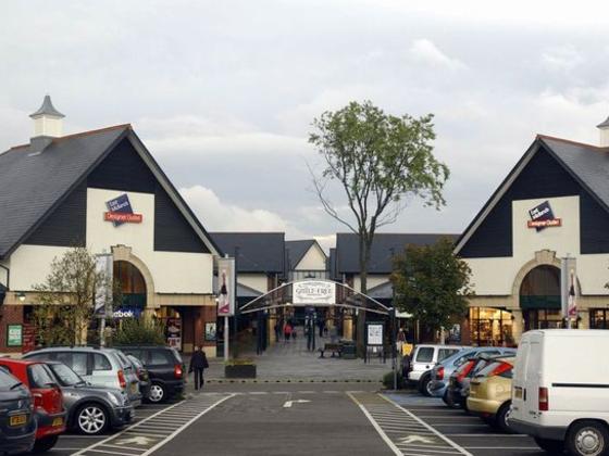 Shopping village with car park in the forefront
