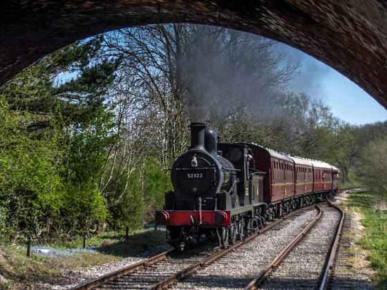 Steam engine approaching a tunnel