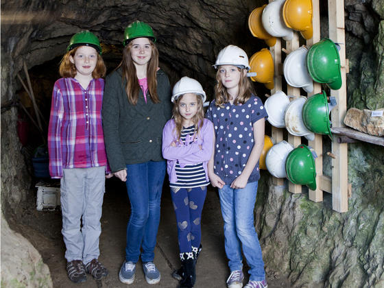 Children in hard hats at the peak district mining museum
