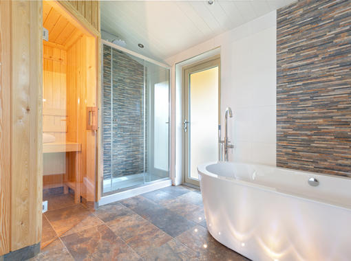 stylish bathroom with large freestanding bath, sauna and large shower cubicle