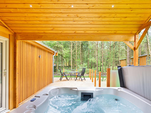 Bubbling outdoor hot tub under wooden canopy