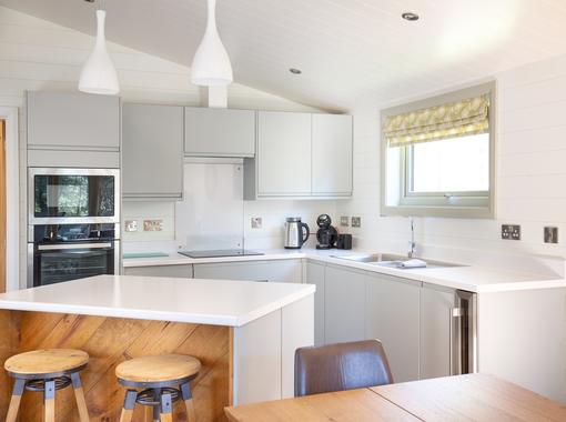 Stylish kitchen with integrated appliances and island unit. breakfast bar to seat 2 people