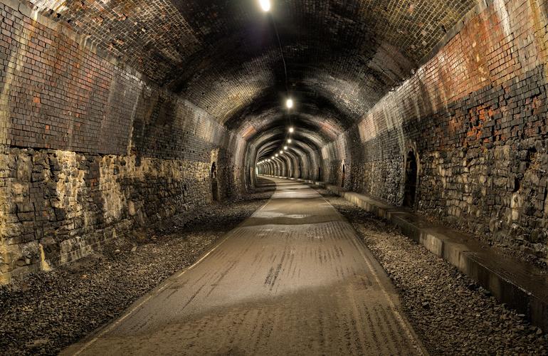 Old lit railway tunnel to walk or cycle through on the monsal trail