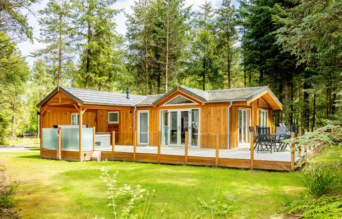 Large log cabin with decking and hot tub