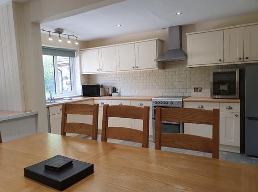 Spacious kitchen area with dining table