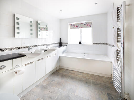 Spacious bathroom with his n hers sinks and full length bath